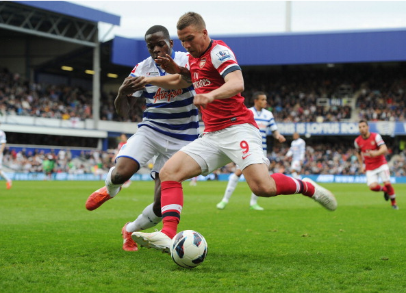 Lukas Podolski Of Arsenal Breaks Past Nedum Onuoha Of QPR… News Photo - Getty Images - 168029951